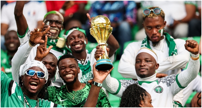 Nigeria's supporters hold a cup ahead of the Africa Cup of Nations (CAN) 2024 quarter-final football match between Nigeria and Angola at the Felix Houphouet-Boigny Stadium in Abidjan on February 2, 2024. (Photo by FRANCK FIFE / AFP